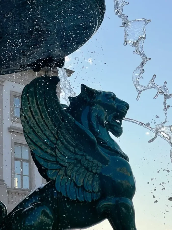 Bronze Winged Lion, or Leão Alado, with water as part of Fonte dos Leões in Porto, Portugal.