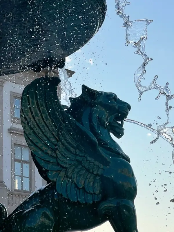 Bronze Winged Lion, or Leão Alado, with water as part of Fonte dos Leões in Porto, Portugal.
